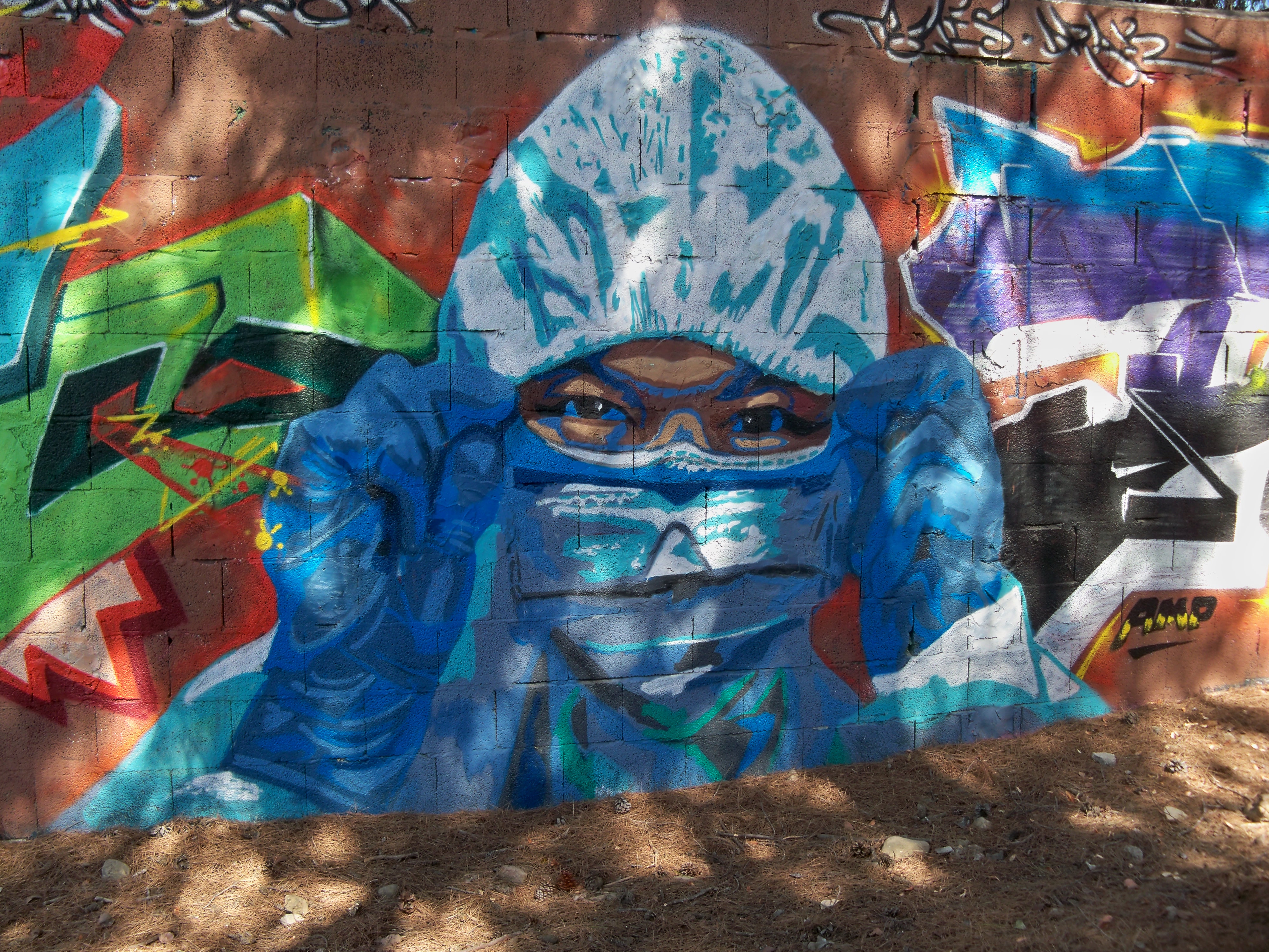 An outdoor mural of geared-up nurse during the COVID pandemic, in Malaga, Spain. The nurse is wearing all possible PPE available.