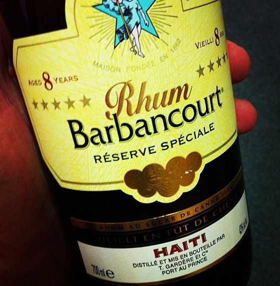Color photograph of the label of a bottle of Barbancourt rum, a staple elixir in Haitian Vodou.