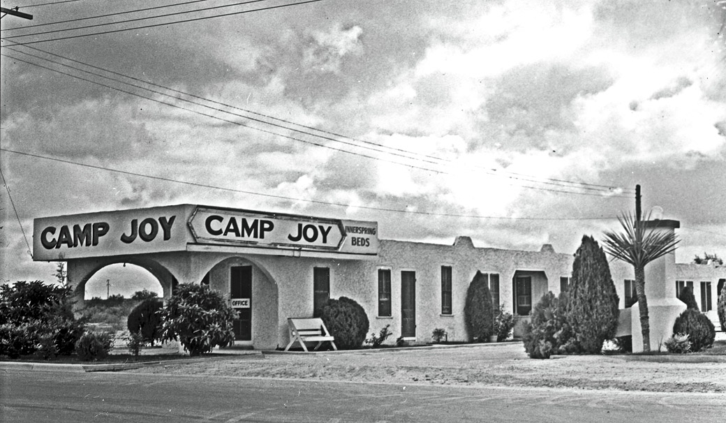 A black and white photograph of Camp Joy, a motor inn in Del Rio, Texas, with innerspring beds. Del Rio would be the site of a camp of hundreds of Haitian migrants beneath an inner state freeway, though few would find any joy there.