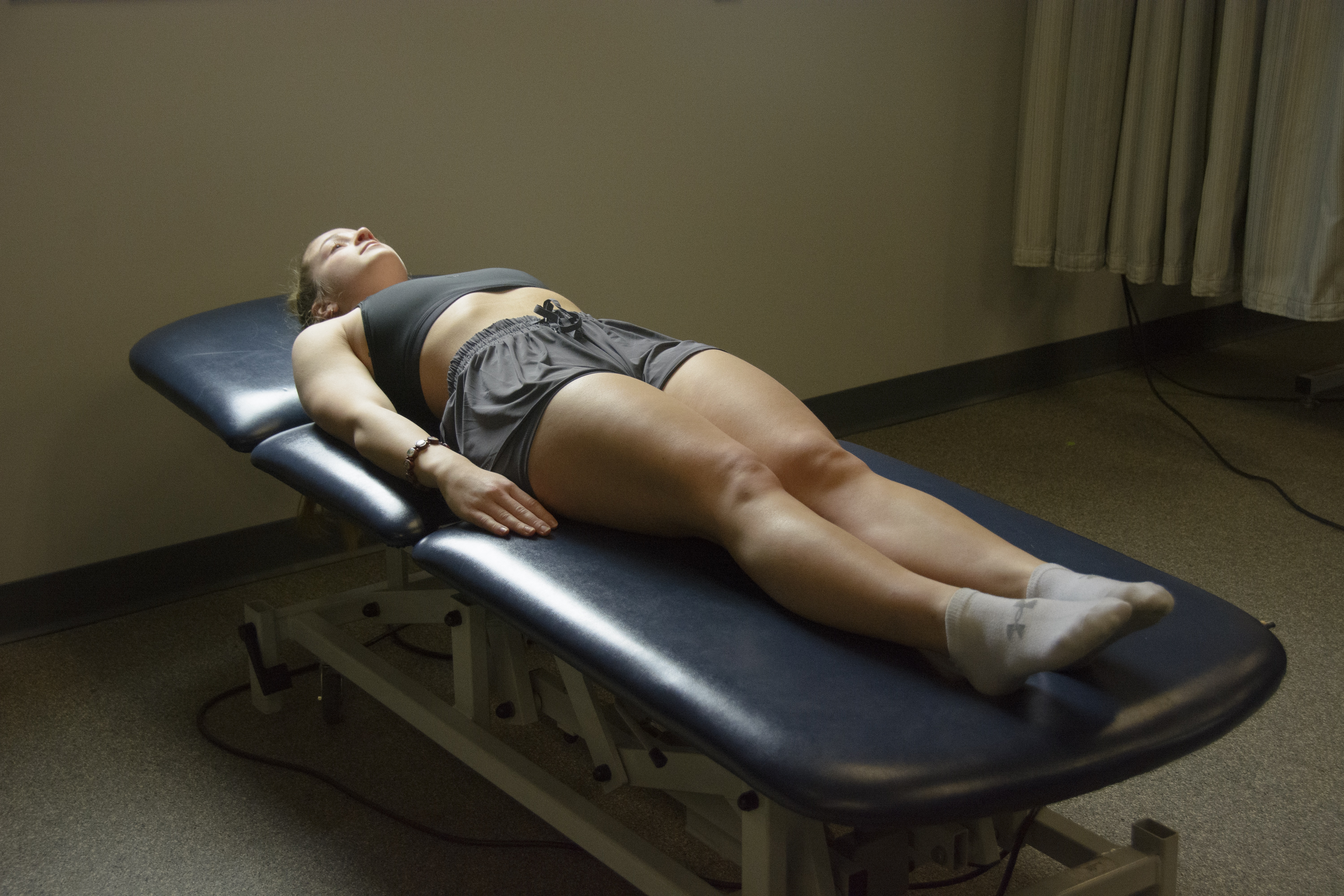 Person laying in the supine position on an examining table.
